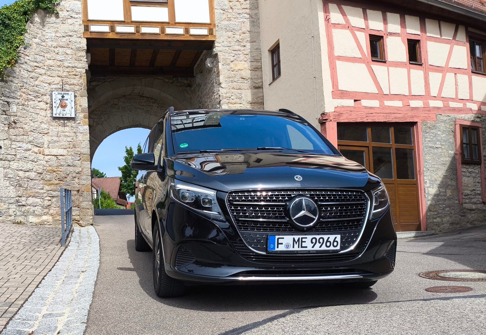 Schwarze Mercedes V-Klasse vor historischem Stadttor – Chauffeurservice und Fernfahrten ab Frankfurt